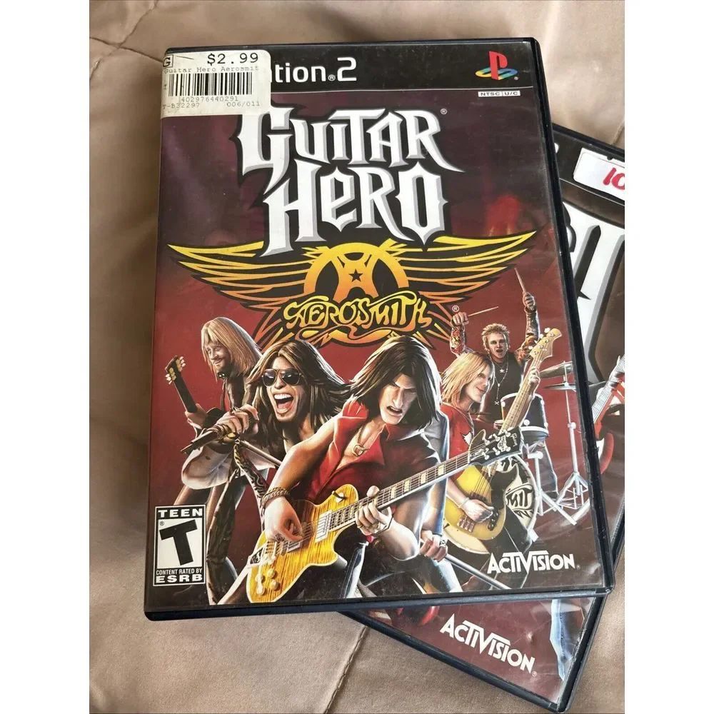 Set Up Two Guitar Hero Games. Guitar Her II And Aerosmith. With Books 2667
